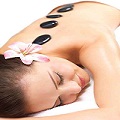Smiling female face - Hot stone massage in the day spa